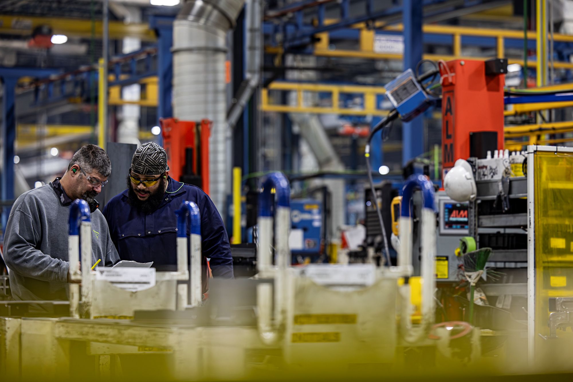 Two men work together on the manufacturing floor of Vermeer.