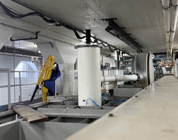 PEAK’s FlexOWC scale‑model device undergoing towing‑tank testing at the Iowa Institute for Hydraulic Research